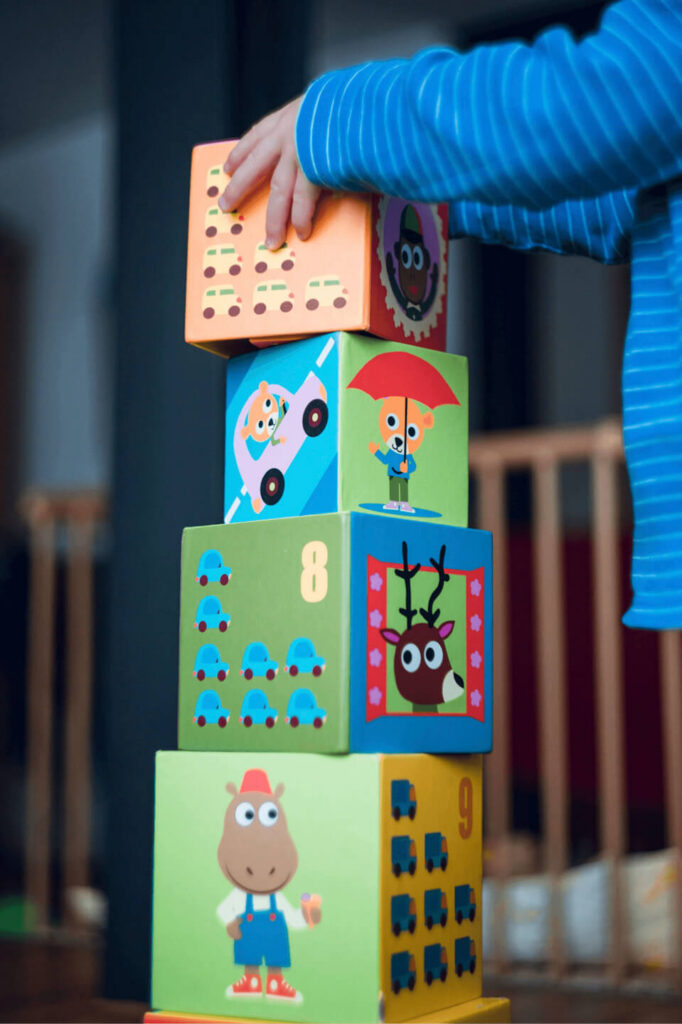 Colourful wooden stacking blocks on a nursery shelf